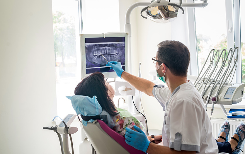 Dentist easing patients nerves by explaining work