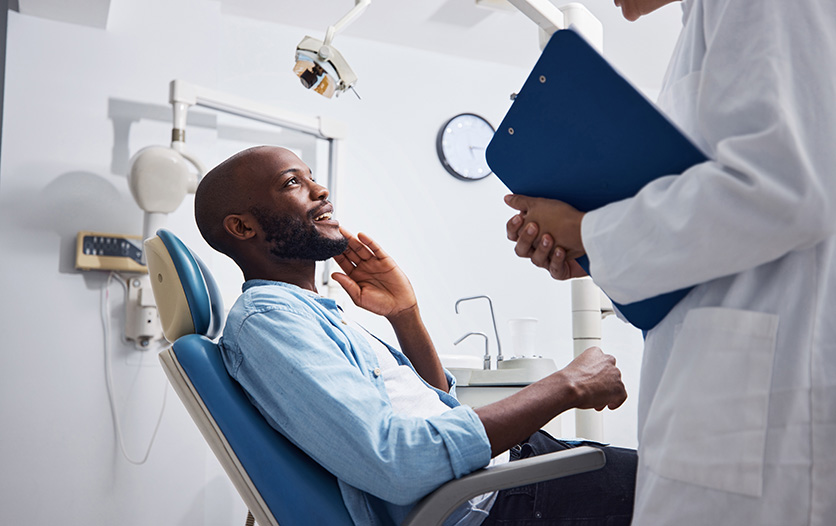 Patient describing pain to dentist during consultation