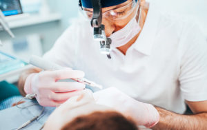 Dentist looking in patient's mouth